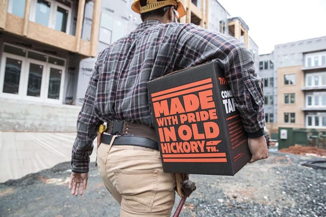 Man carries Construction Tape Box