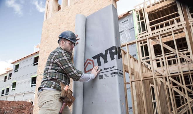 Construction worker installs commercial metro building wrap